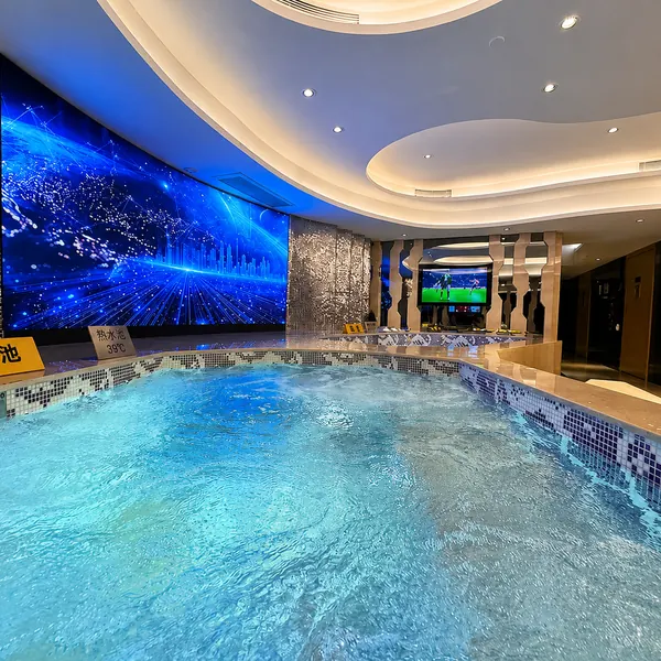 Blue-lit mosaic pool area
