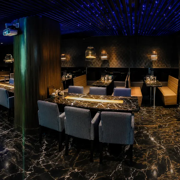 Black-and-gold dining lounge with display shelves