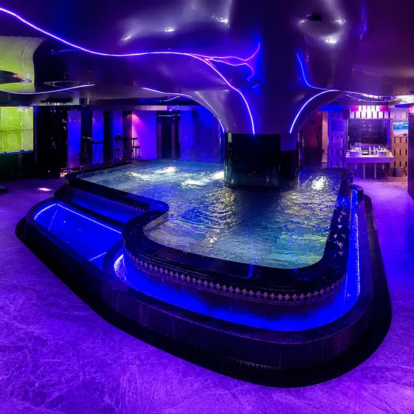 Curved jacuzzi area with purple lighting