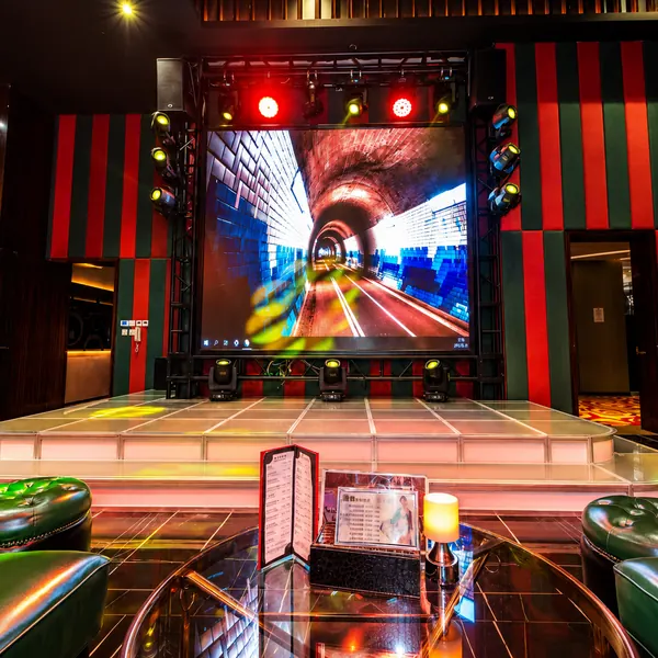 Theatre-style stage hall with colorful lighting