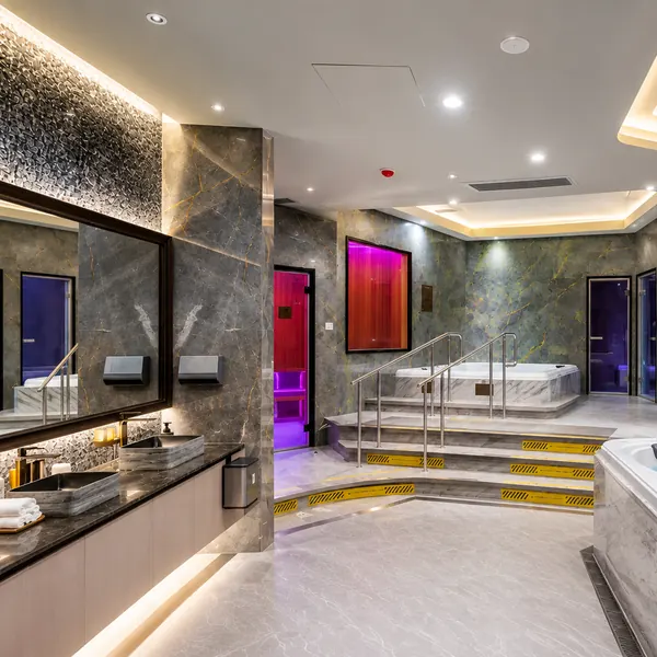 Bright marble bathing area with shower space