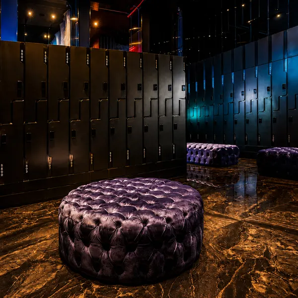 Black-and-gold locker room with leather ottoman