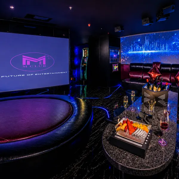 Blue-purple KTV suite with a curved screen