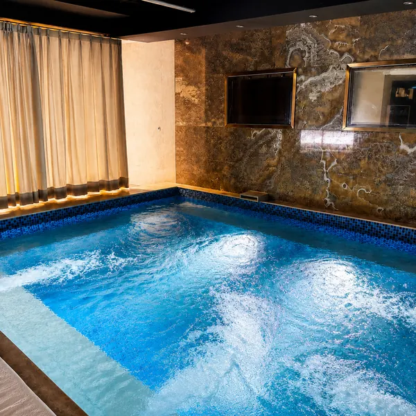 Private blue-lit soaking pool room